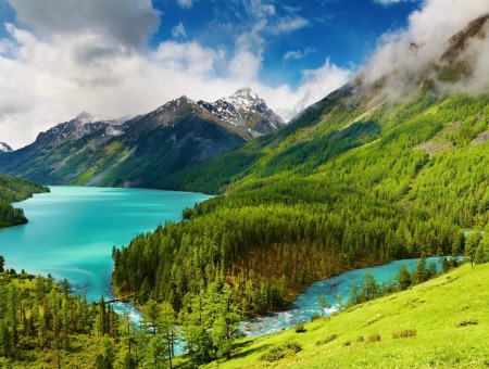 Green Mountains Near Turquoise Body Of Water Under Blue White Sky