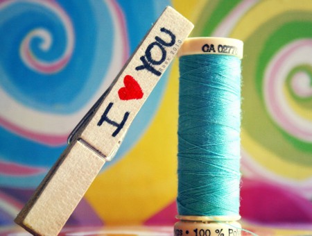 I Love You Clothes Pin Beside Blue Thread
