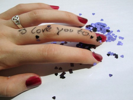 Human Hand With Silver Wedding Band Red Manicure And Iloveyou Tattoo
