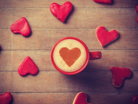Red Heart Cutout Near Beige Heart Shaped Coffee On Red Mug