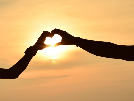 Sunlight Through Couple Forming Heart Shaped Hand
