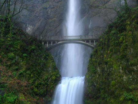 Bridge Between Two Mountain Range Infront Of Waterfalls