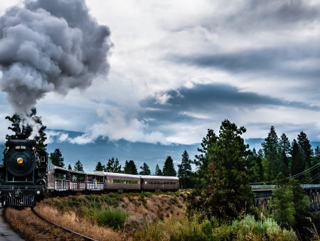 Black Steam Engine Train On Rail Road Under Gray Clouds