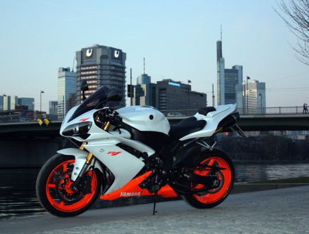 White Orange And Black Sports Motorcycle Near Body Of Water