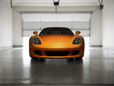 Orange Porsche Carrera Gt Parked Inside Garage