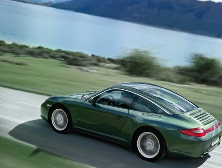 Gray Coupe Travelling On Gray Narrow Road Beside Green Grass Field During Daytime