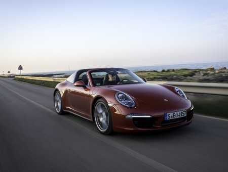 Red Porsche Traveling On Road