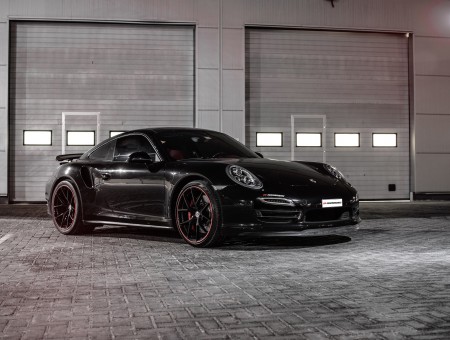 Black Porsche Carrera Parked Inside Garage