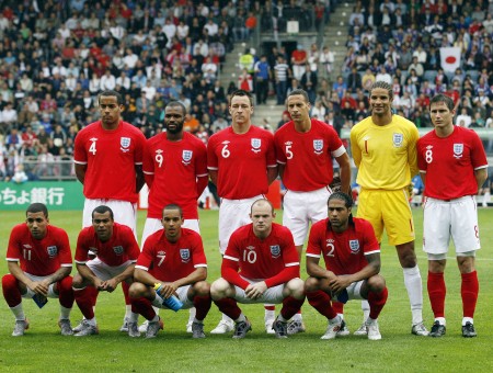 Men In Red Soccer Jerseys On Field Posing For Photo