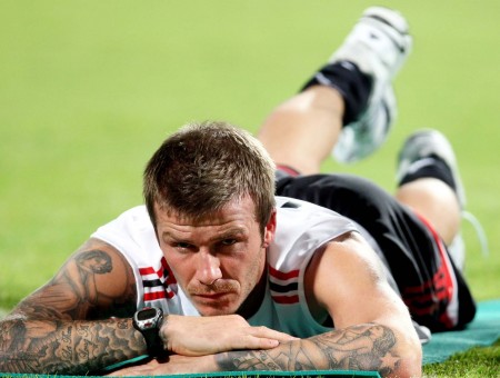 Man In White Black And Red Jersey Tank Top And Black Shorts Lying In Prone Position