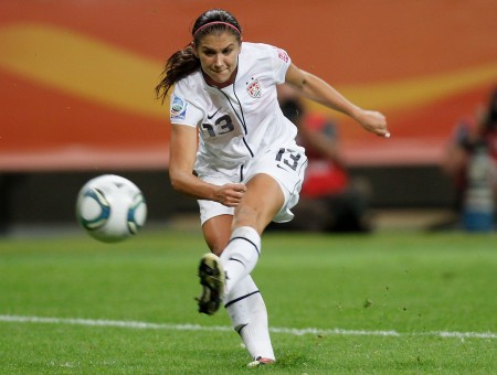 Woman In White Jersey Kicking Soccer Ball
