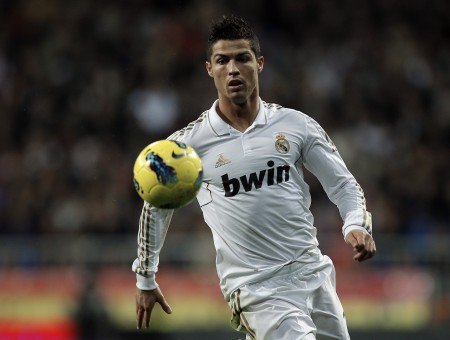 Man In White Bwin Soccer Jersey With Yellow Soccer Ball In Mid Air
