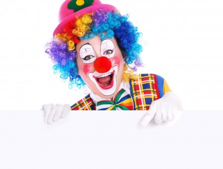 Clown Wearing Pink Hat Red Yellow And Blue Plaid Shirt Smiling At The Camera