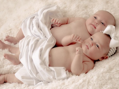 2 Topless Baby Lying On White Textile