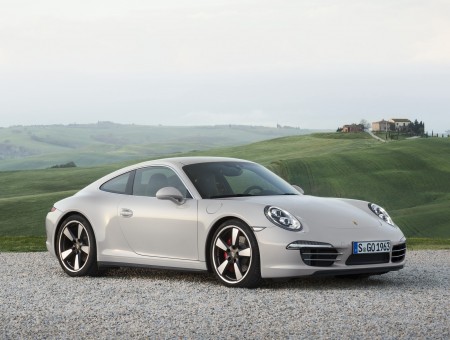 White Porsche 911 In Front Of Rolling Fields At Daytime