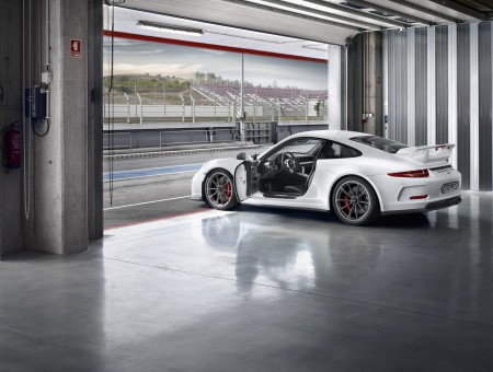 White Porsche 911 Parked In Garage At Race Track