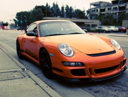 Orange Porsche 911 GT3 RS Parked On City Street At Daytime