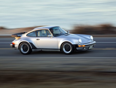 Silver Classic Porsche 911 Driving At Sunset