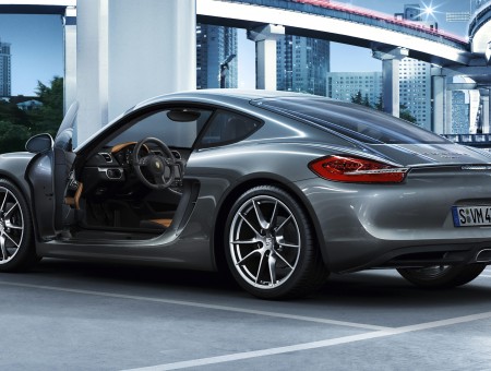 Grey Porsche Cayman Parked On Parking Lot