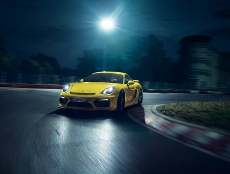 Yellow Porsche Cayman On Asphalt Road In Panning Photograph During Nighttime