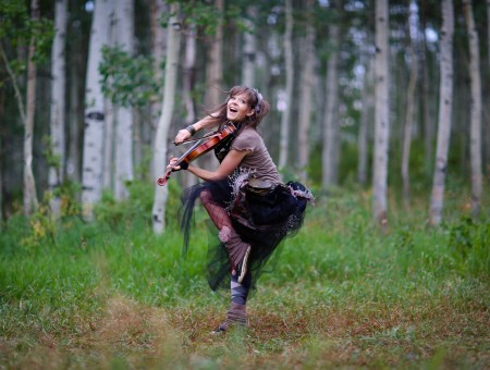 Smiling Woman Wearing Brown Shirt And Skirt Dancing In Forest