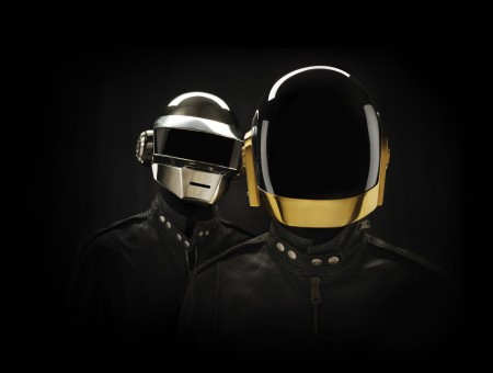 Two People In Black Racking Jackets With A Gold And Silver Face Helmet