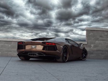 Brown Lamborghini Parked On Gray Concrete Pavement