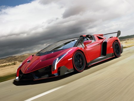 Red Lamborghini Veneno Driving On Country Road At Daytime
