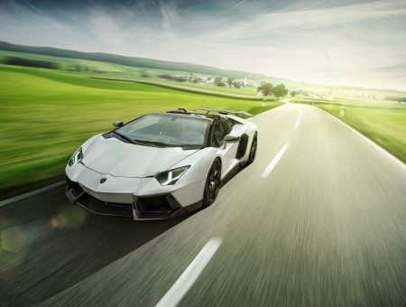 White Lamborghini Aventador Driving On Country Road At Daytime