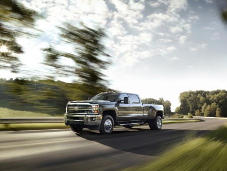 Grey Chevrolet Silverado Crew Cab Pick Up Truck Traveling On Road During Daytime