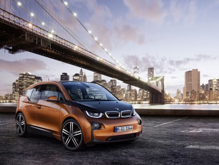 Black And Brown BMW i3 Under A Bridge In A City At Sunset