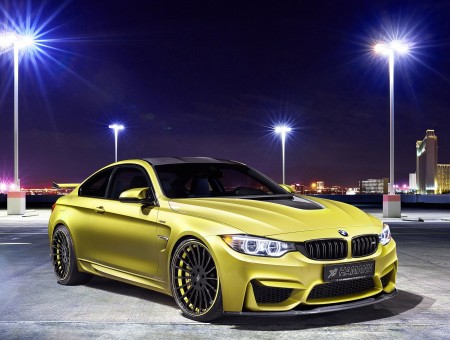 Yellow BMW Coupe On Gray Cement Road During Night Time