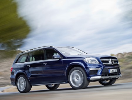 Blue Mercedes Benz SUV On Road During Daytime