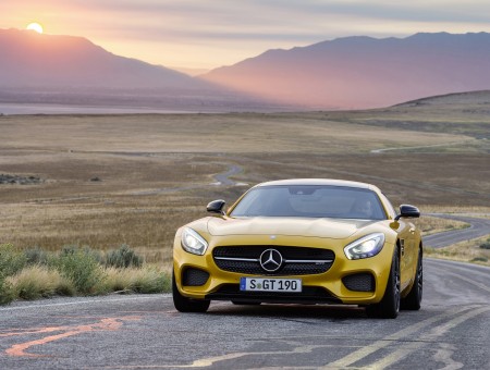 Yellow Mercedes Benz AMG GTS Driving On Country Road At Sunset