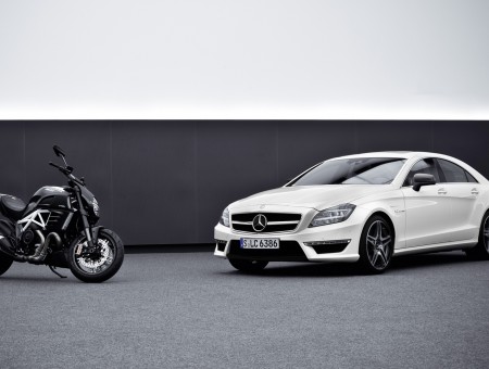 White Mercedes Sedan Beside Black Motorcycle