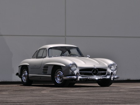 Silver Mercedes Benz 300 SL In Front Of White Wall