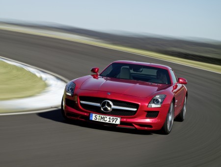 Red Mercedes Benz Sports Car On Racetrack At Day Time