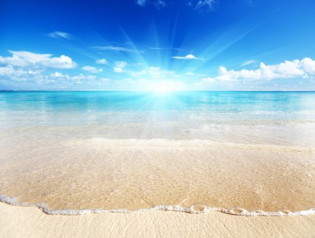 Seashore With Ray Of Sunlight With Blue Sky And White Clouds