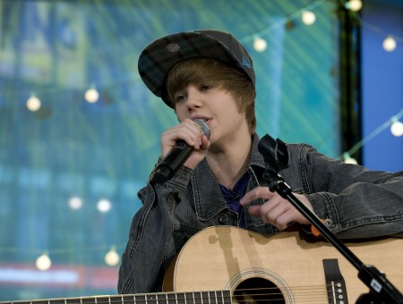 Justin Bieber In Grey Denim Jacket Holding Black Cordless Microphone And Brown Acoustic Guitar