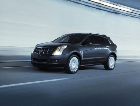 Black Cadillac SRX On The Road In Panning Photograph During Daytime