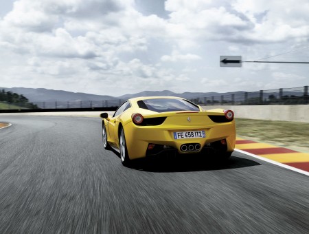 Yellow Ferrari 458 Italia Driving On Track At Daytime
