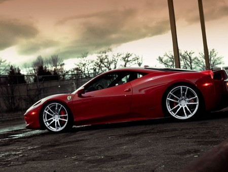 Red Ferrari 458 Italia Parked Near Wooden Post Under Cloudy Sky During Daytime