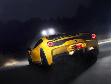 Yellow Ferrari Sports Car Travelling On Gray Asphalt Road With Lighted Light Post At The Side During Nighttime
