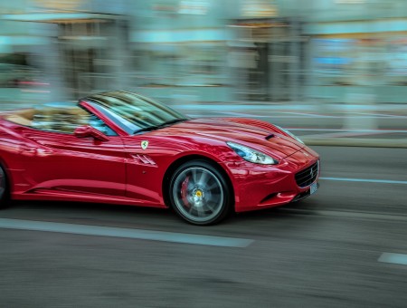 Red Ferrari California Convertible Running On Road