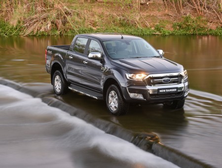 Grey Ford F150 Crew Cab Pickup Truck Crossing River