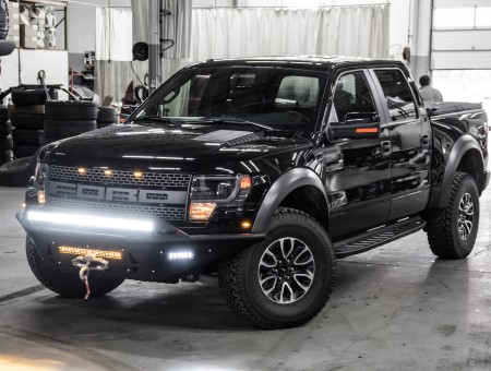 Black Ford Raptor Crewcab Pickup Truck Inside A Garage