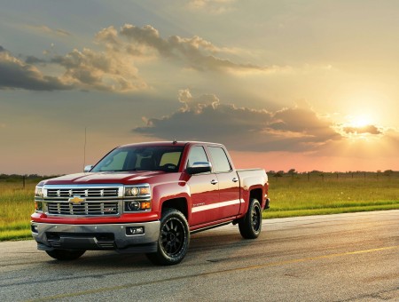 Red Chevrolet Silverado Truck On Countryside Road At Dusk