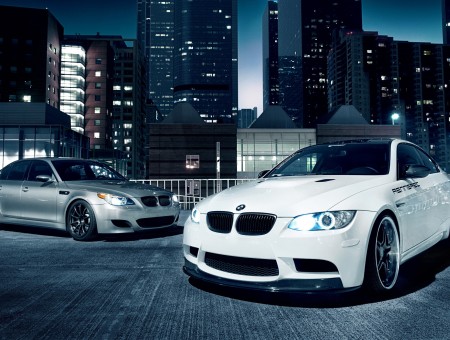 White BMW Coupe Parked Beside Silver BMW Sedan
