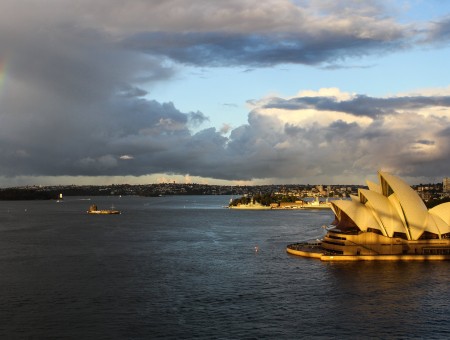 Sydney Australia With A Storm And Rainbow In The Distance On A Sunny Afternoon