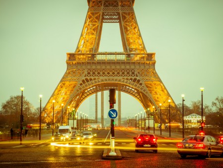 Eiffel Tower With Black Asphalt Road And Vehicles